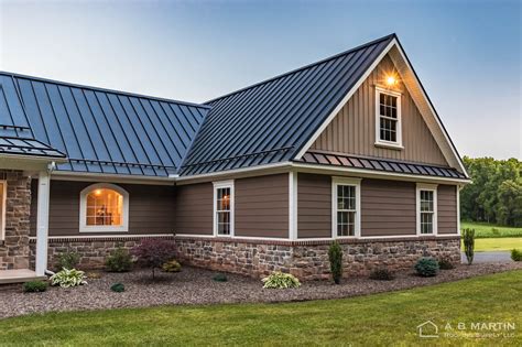 brown house with black metal roof|siding colors with black roof.